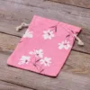 Sachet en lin imité 15 x 20 cm avec l'impression - naturel / fleurs roses En voyage